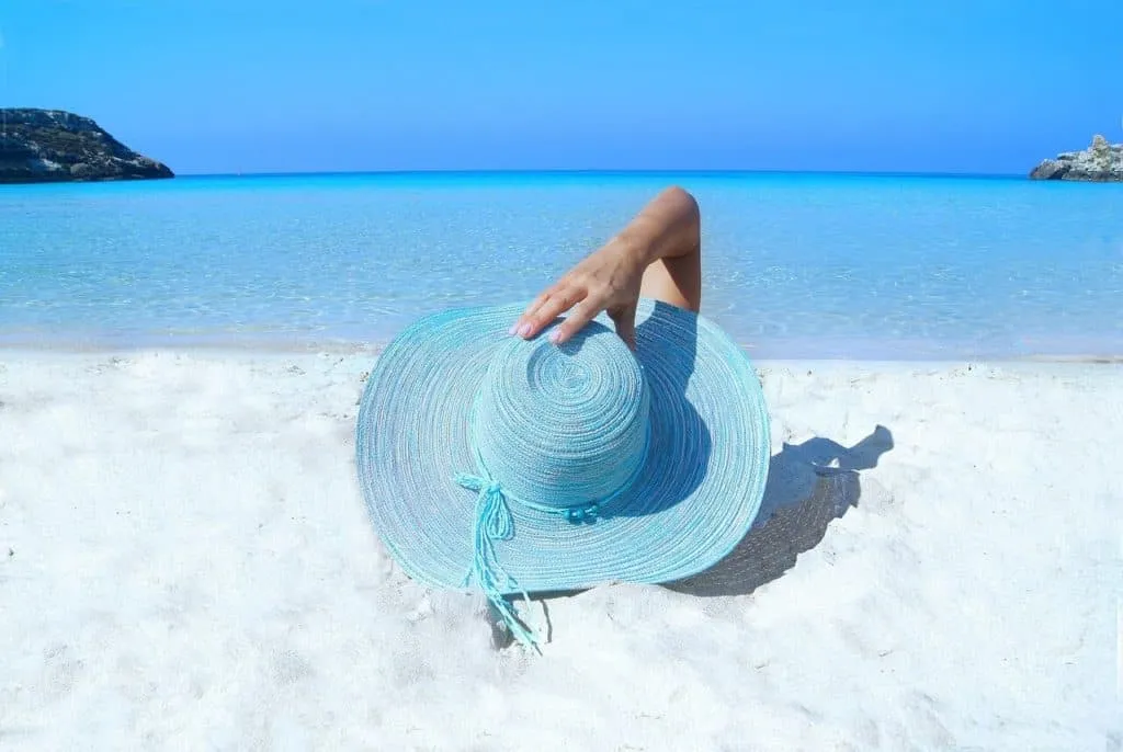 Tourists relaxing on a white sandy beach at the Kenyan coast